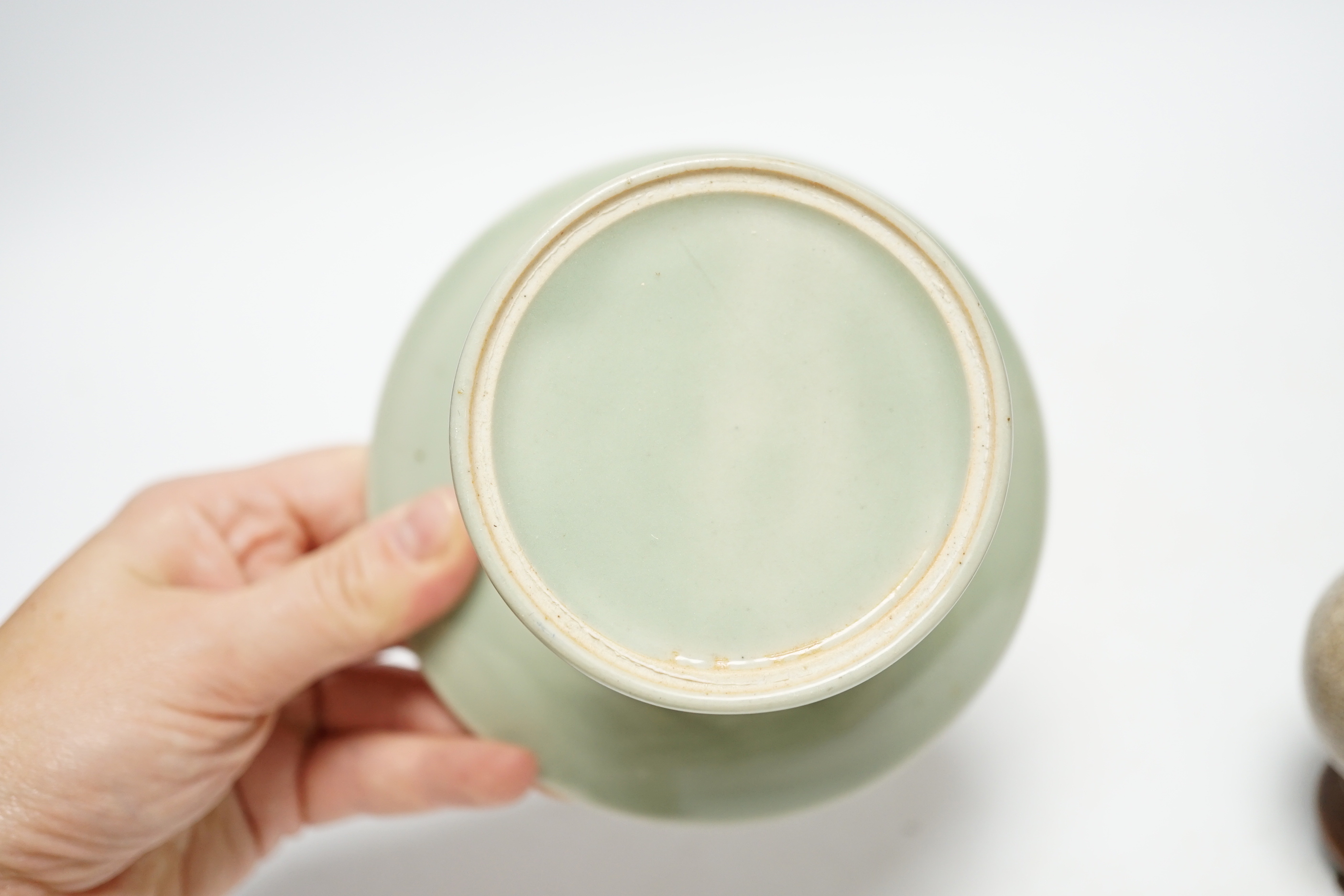 A Chinese celadon glazed 'dragon' puzzle cup and stand, early 20th century and a Chinese crackle glaze vase, 19th century, cup 7.5cm